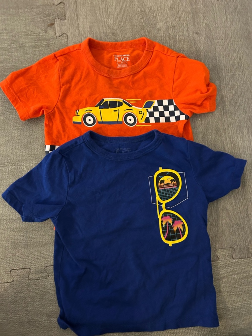 The Children's Place Orange and Blue Graphic Tee Set. (2 shirts)